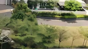 A residential area with a modern house, a driveway, and a well-maintained lawn. - Meridin Bayvue (Plentong)