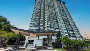 A high-rise residential building with a modern design, featuring multiple balconies and a covered entrance area. - Vision Residence By Fei Hong (Puchong)
