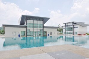 A modern building with a pool in front. - Vision Residence By Fei Hong (Puchong)