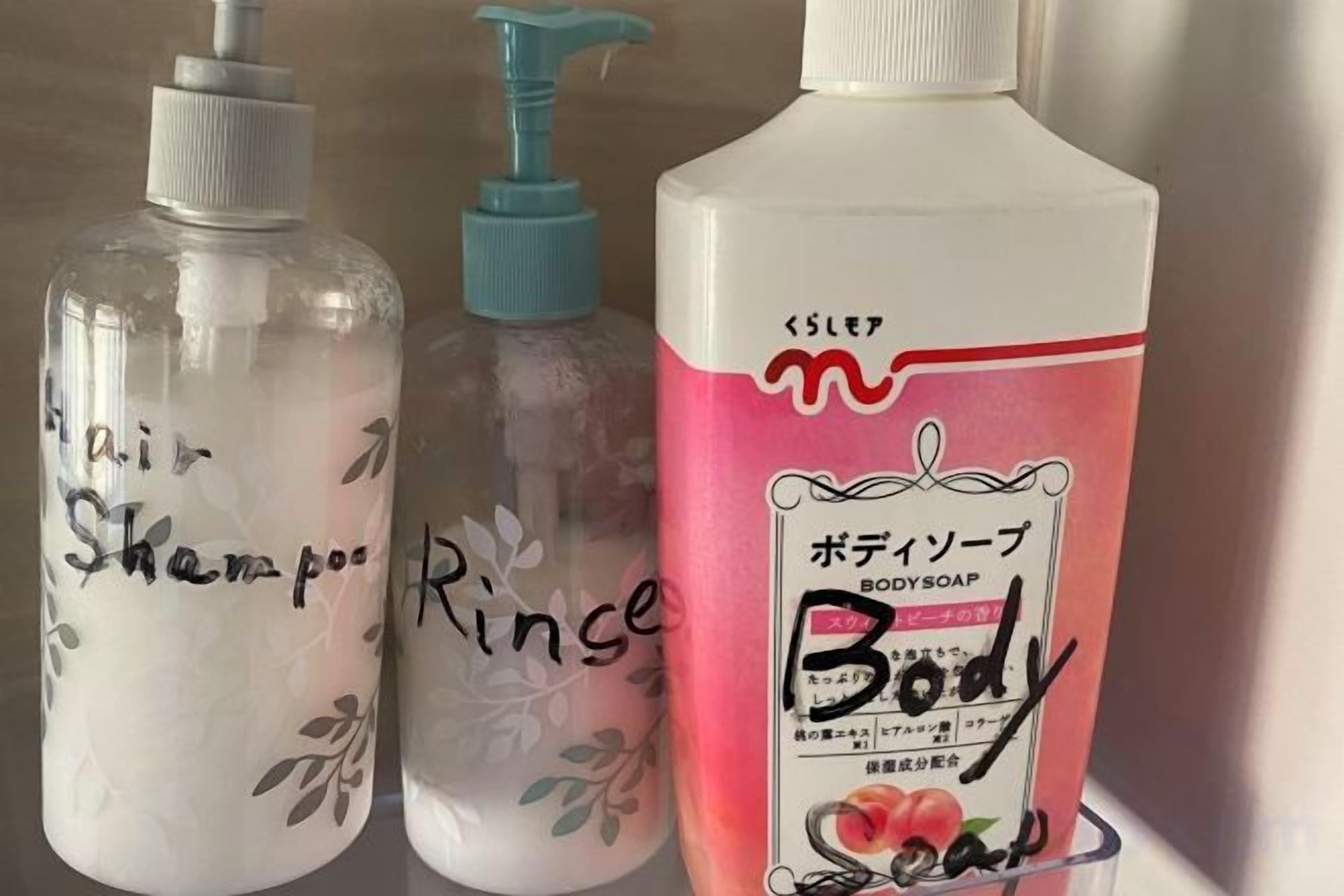 Three bottles of liquid with labels, one of which is pink and has Japanese text.