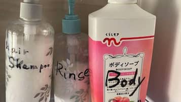 Three bottles of liquid with labels, one of which is pink and has Japanese text.