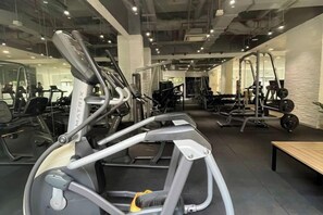 A gym with various exercise equipment, including treadmills and weight machines. - The Wellington Homes - Botanica Premier Apartment - Nearby Airport Free Pool Gym (Ho Chi Minh City)
