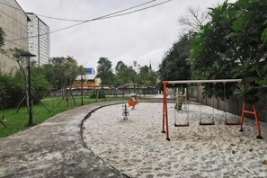 A playground with swings and a sandbox area. - The Wellington Homes - Botanica Premier Apartment - Nearby Airport Free Pool Gym (Ho Chi Minh City)