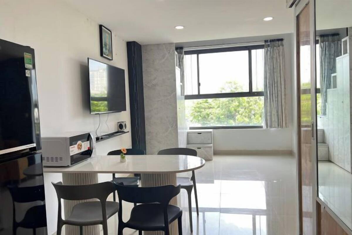 A modern kitchen with a built-in oven, a microwave, and a coffee machine.