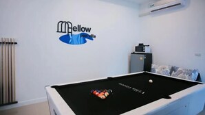A pool table with a logo on the wall, a radiator, and an air conditioning unit. - 3 Bedroom Villa Green Mellow-Pattaya (Bang Lamung)