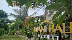 A sign for Wanbal Resort with a tropical garden background. - Wani Bali Resort 2 (Bali)