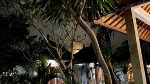 A tropical indoor setting with a wooden structure and lush greenery. - Wani Bali Resort 2 (Bali)
