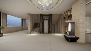 A spacious, modern interior with a large window, a staircase, and a unique water feature. - Myrica Groves Lansdowne (Lansdowne)