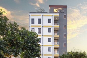 A multi-story building with a modern design, featuring balconies and a prominent logo at the top. - Bcons PS Bien Hoa Hotel (Bien Hoa)
