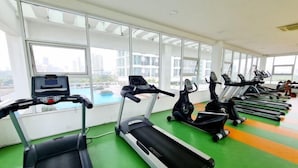A gym with treadmills, ellipticals, and stationary bikes.