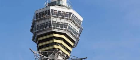 A tall, multi-level tower structure with a clear sky background.