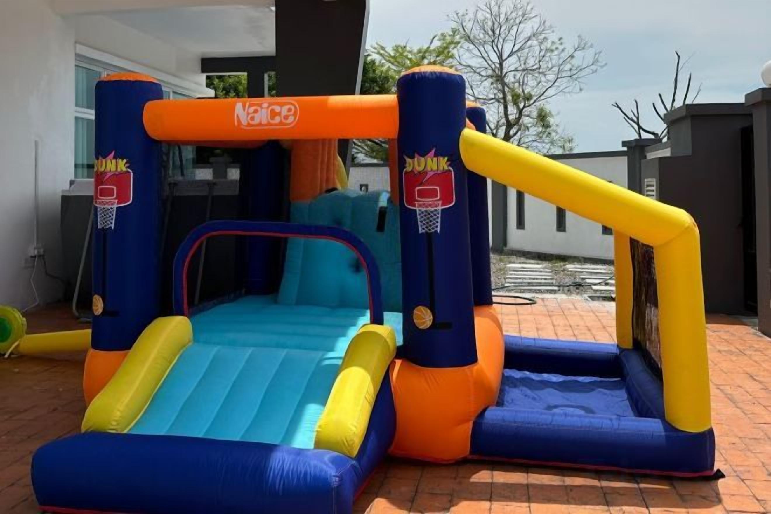 An inflatable basketball court with a blue and orange color scheme, featuring a hoop and a goal area.