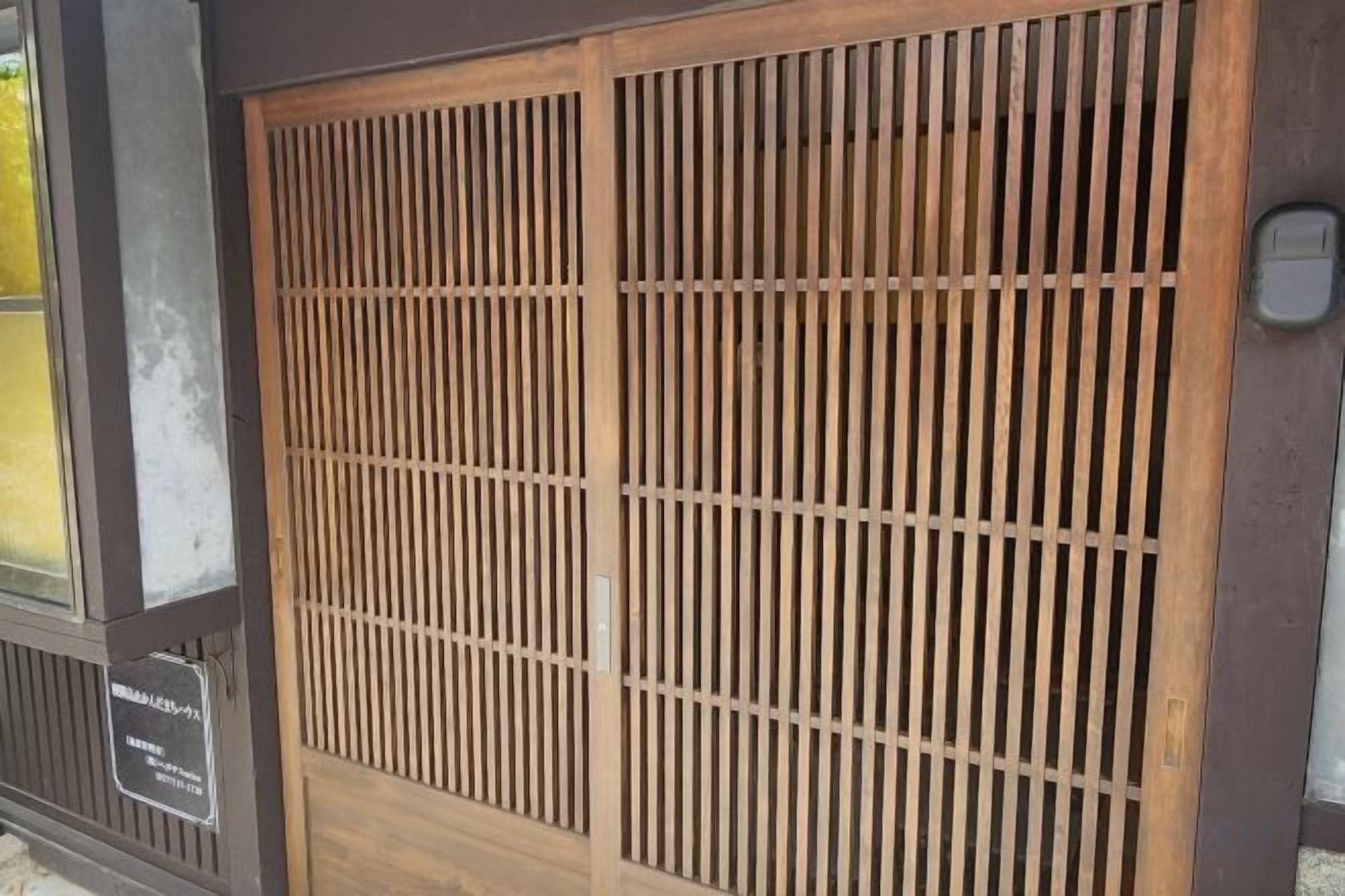 A traditional Japanese sliding door with vertical slats.