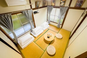A tatami mat room with two tatami mats, a small table, and two cushions. - Ikebukuro Free Pickup#Ueno 14 mins Nippori 10 mins Entire property Up to 7 guests B (Tokyo)