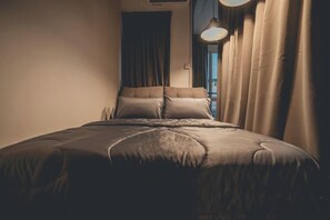 A bedroom with a bed, curtains, and a window. - Modern Luxury Shoplot Style Sutera 3BR 10pax (Johor Bahru)