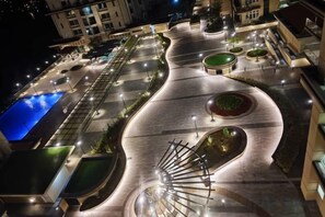 A well-lit, landscaped urban area with a winding pathway, a pool, and a spiral staircase. - Comfy Homestay River View Kuching 4 pax (Kuching)