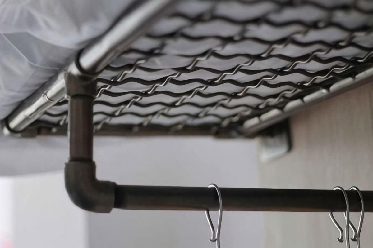 A metal gutter system with a corrugated roof above.