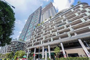 A modern high-rise building with the name 'TRION' prominently displayed. - Trion KL by Vivid Stay (Kuala Lumpur)