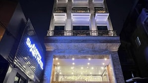 A hotel entrance with a prominent sign, large windows, and a well-lit facade. - Legend Smart Hotel (Hanoi)