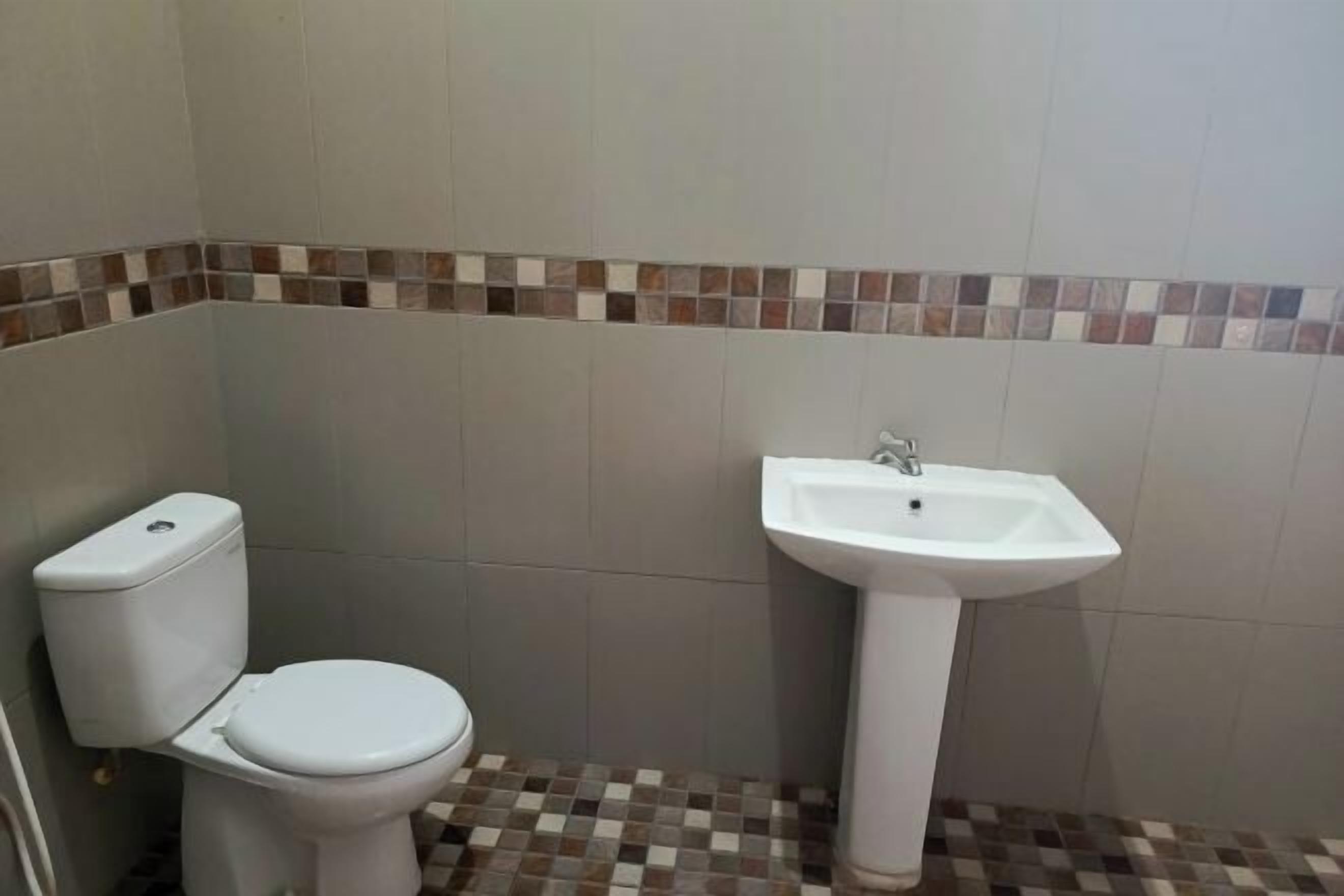 A small bathroom with a toilet and a sink.