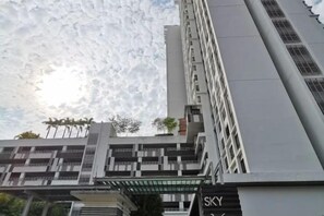 A multi-story building with a modern architectural design, featuring balconies and a prominent entrance. - Bukit Indah Near Aeon and Legoland Johor with Netflix (Johor Bahru)