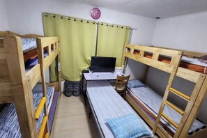 A dormitory room with bunk beds, a desk with a laptop, and a chair. - Exclusive Use Whole House for You (Busan)