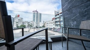 A balcony with a view of a cityscape, including a tall building with a McDonald's sign. - Casablanca Maarif City Center (Casablanca)
