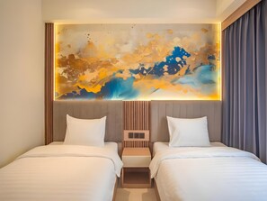 A hotel room with two beds, a large abstract painting on the wall, and a wooden headboard.