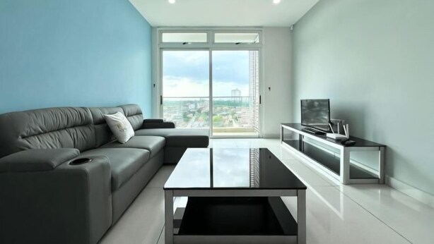 A modern living room with a grey sofa, a coffee table, and a TV on a stand. - KSL D'Esplanade 2Bedrooms 7-8pax Shopping Heaven (Johor Bahru)