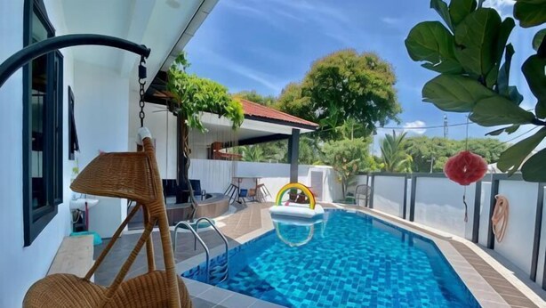 A swimming pool with a wicker chair and a small inflatable pool. - Fairy Retreat Private Pool@12-13pax (Ipoh)