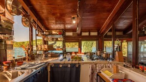 A rustic kitchen with wooden beams, a sink, and various cooking utensils. - Villa Zora - Private Island Retreat (Sali)