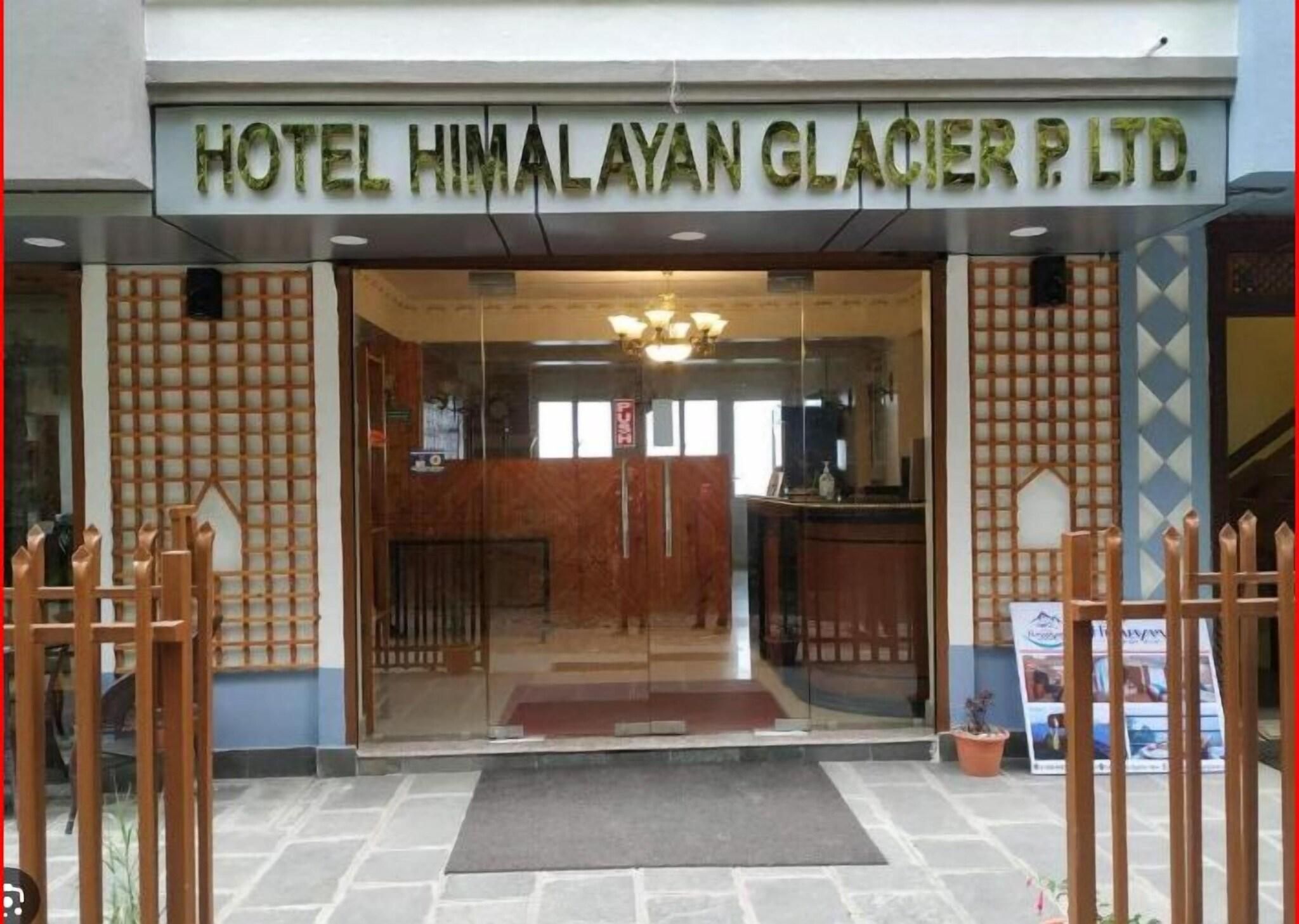 De ingang van Hotel Himalayan Glacier P. Ltd., met een receptiebalie en een bord boven de deur.