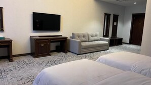 A hotel room with two beds, a TV, a desk, a chair, and a wardrobe. - Grand Plaza Hotel Samarkand (Samarkand)