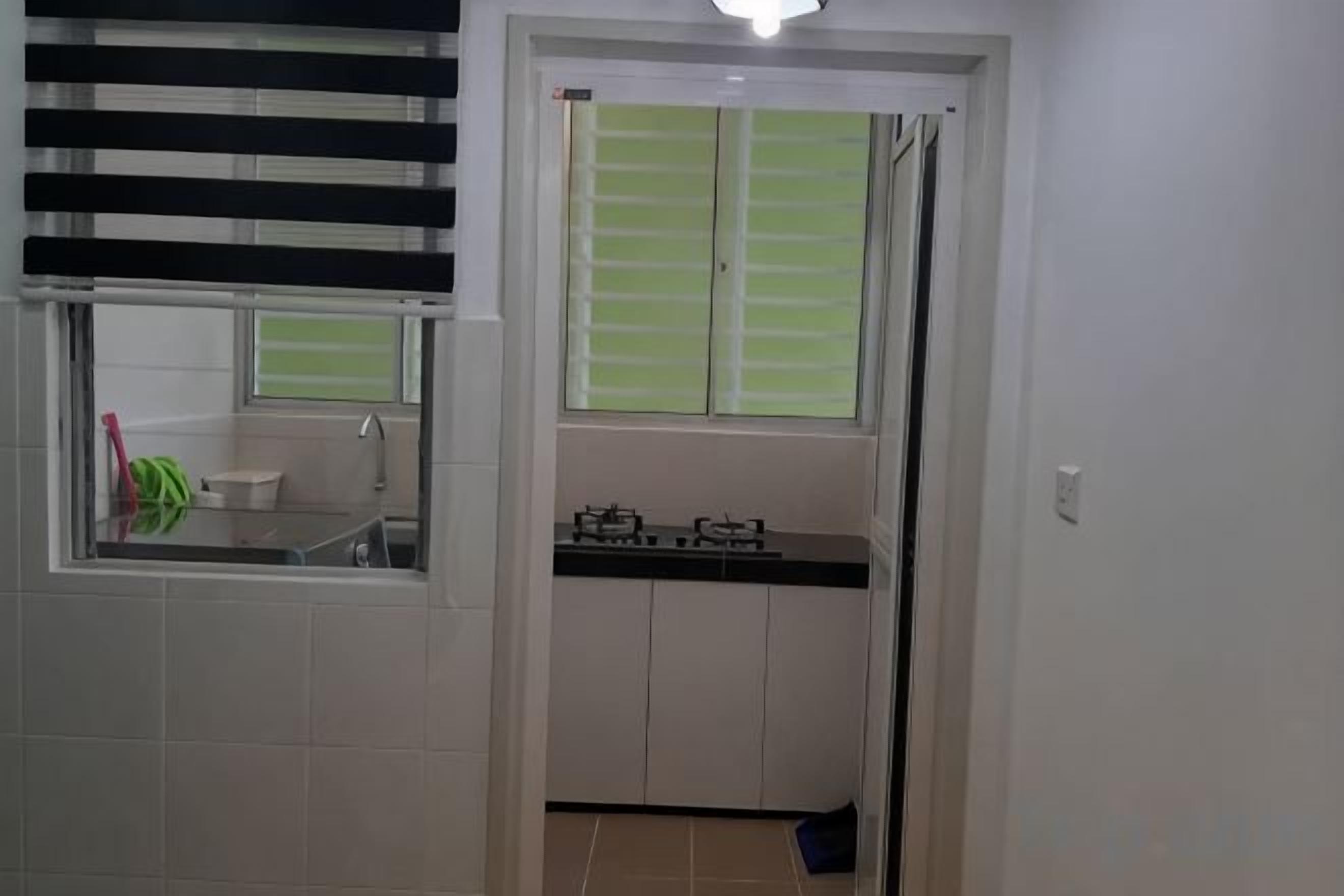 A bathroom with a window, a sink, and a toilet.