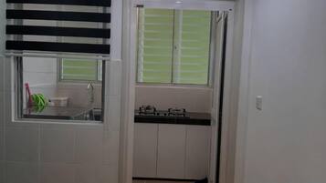 A bathroom with a window, a sink, and a toilet.