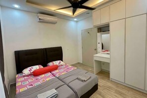 A bedroom with a bed, a ceiling fan, an air conditioner, a wardrobe, and a small bathroom. - 3R@7pax++ Spacious Space Putrajaya. (Putrajaya)