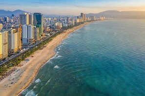 Un paisaje urbano costero con playa y edificios altos.