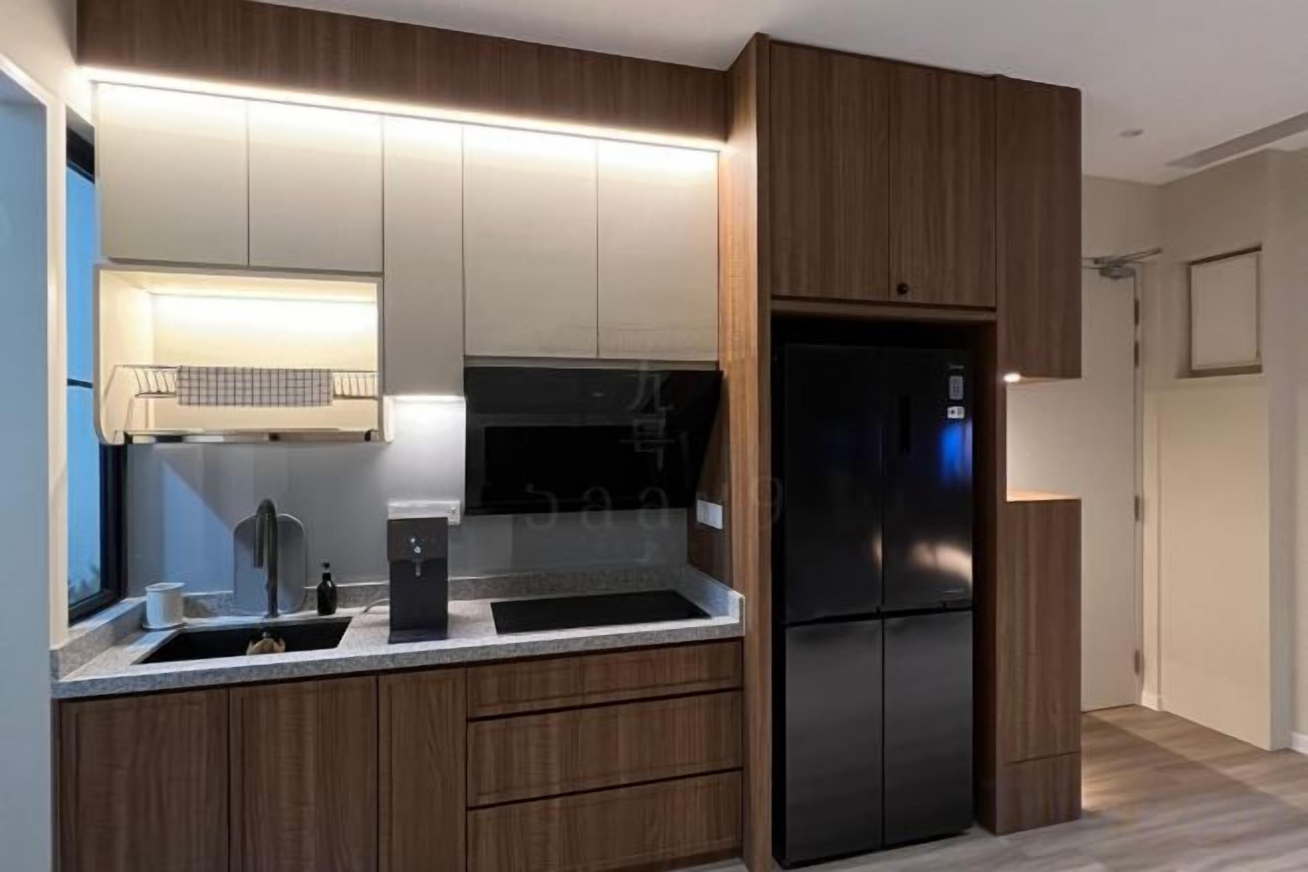 A modern kitchen with built-in appliances, wooden cabinets, and a stainless steel sink.