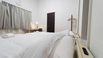 Hypo-allergenic bedding, desk, laptop workspace, blackout curtains