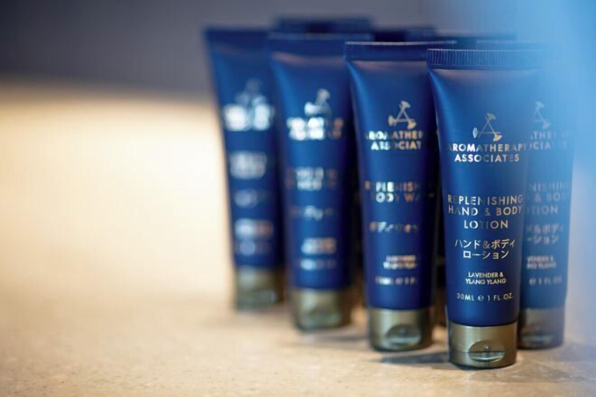 A row of blue lotion bottles with text on them.