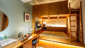 A compact, modern room with a bunk bed, a desk with a chair, a mirror, and a framed picture on the wall. - Hotel Ao Kanazawa (Kanazawa)
