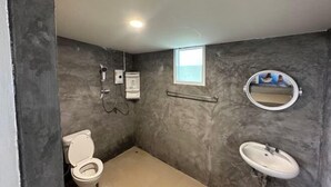A bathroom with a toilet, sink, shower, and a small window. - INK-PHA GARDENVIEW RESORT (Noen Maprang)