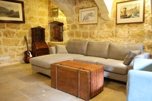 TV, fireplace - Rustic Xagħra Farmhouse with Pool, Garden & BBQ (Xagħra)