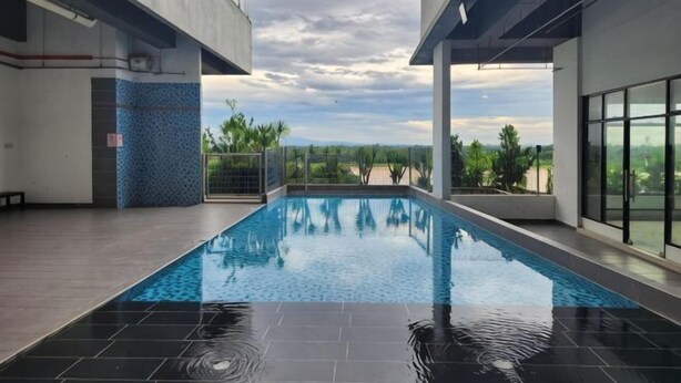 A swimming pool with a view of the landscape, surrounded by modern architecture. - Sky River Front Kota Bharu @ AGhome (Kota Bharu)