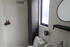 A bathroom with a toilet, sink, and a window. - Sky River Front Kota Bharu @ AGhome (Kota Bharu)