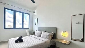 A modern bedroom with a bed, bedside tables, a nightstand, and a large window with a city view. - Sky River Front Kota Bharu @ AGhome (Kota Bharu)