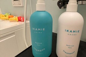 Two bottles of Ikamie's Cosme products on a bathroom counter. - YiyashiHikari Fujiyoshida No.2 (Fujiyoshida)