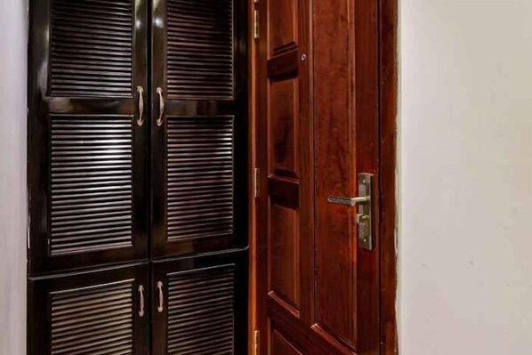 A wooden door with a metal handle and a keyhole. - Lotus Laverne Hotel (Ho Chi Minh City)