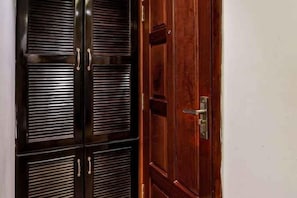 A wooden door with a metal handle and a keyhole.
