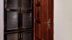 A wooden door with a metal handle and a latch.